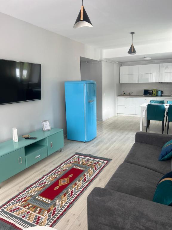 a living room with a couch and a blue refrigerator at Lucky Number in Sinaia