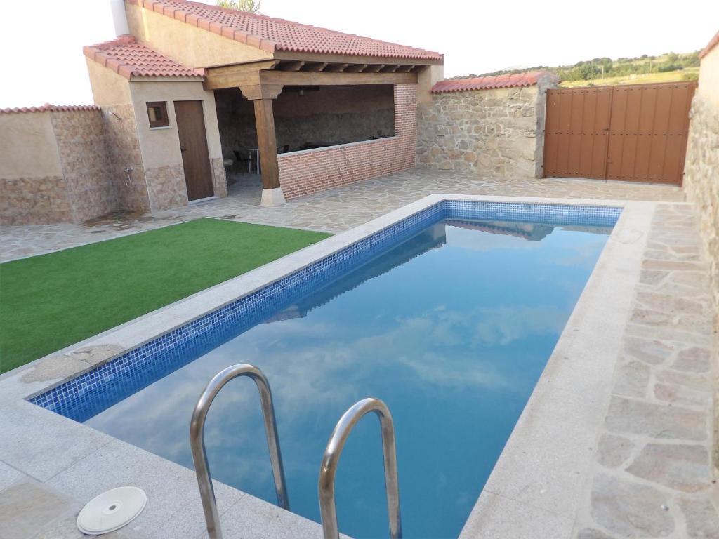 a swimming pool in the backyard of a house at Casa Armonia in Ávila