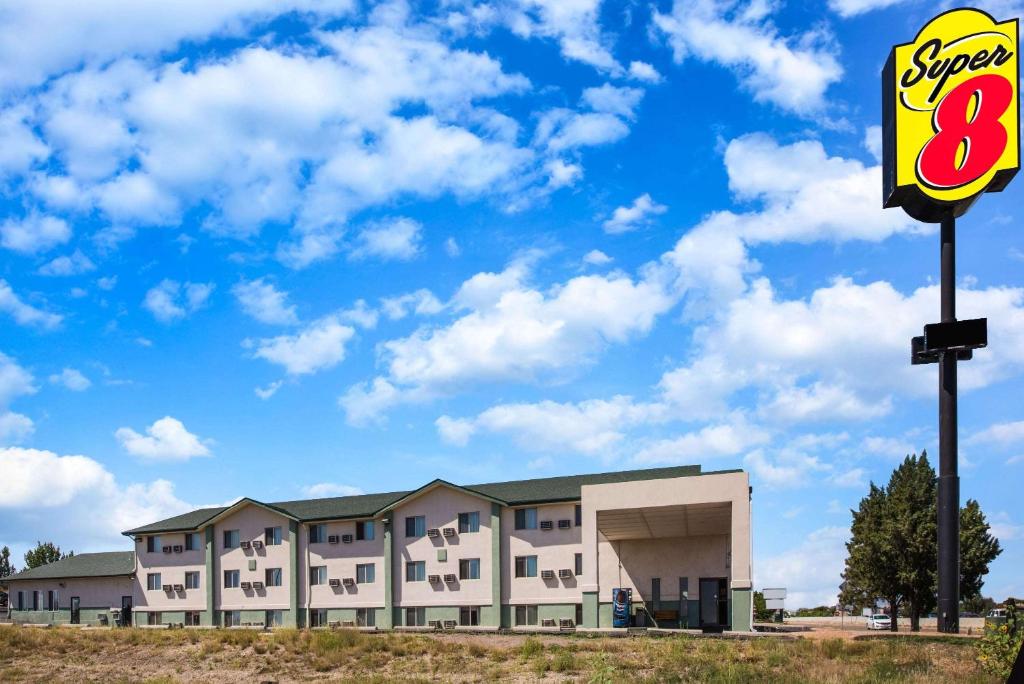 a building with a sign in front of it at Super 8 by Wyndham Pueblo in Pueblo