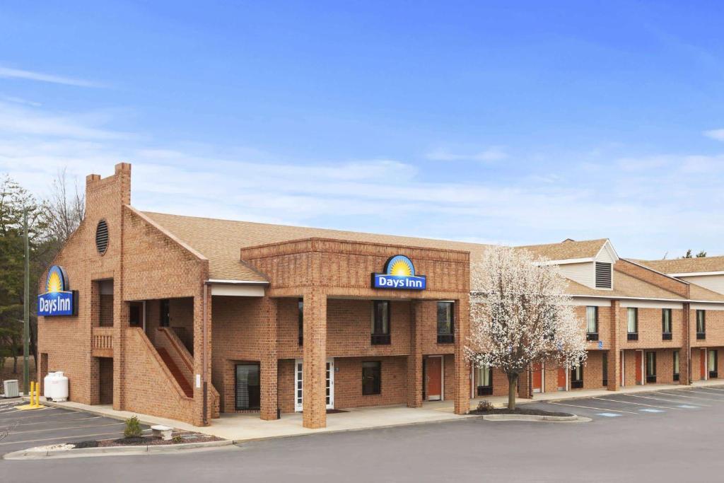 a large brick building with a sign for a hospital at Days Inn by Wyndham Farmville in Farmville