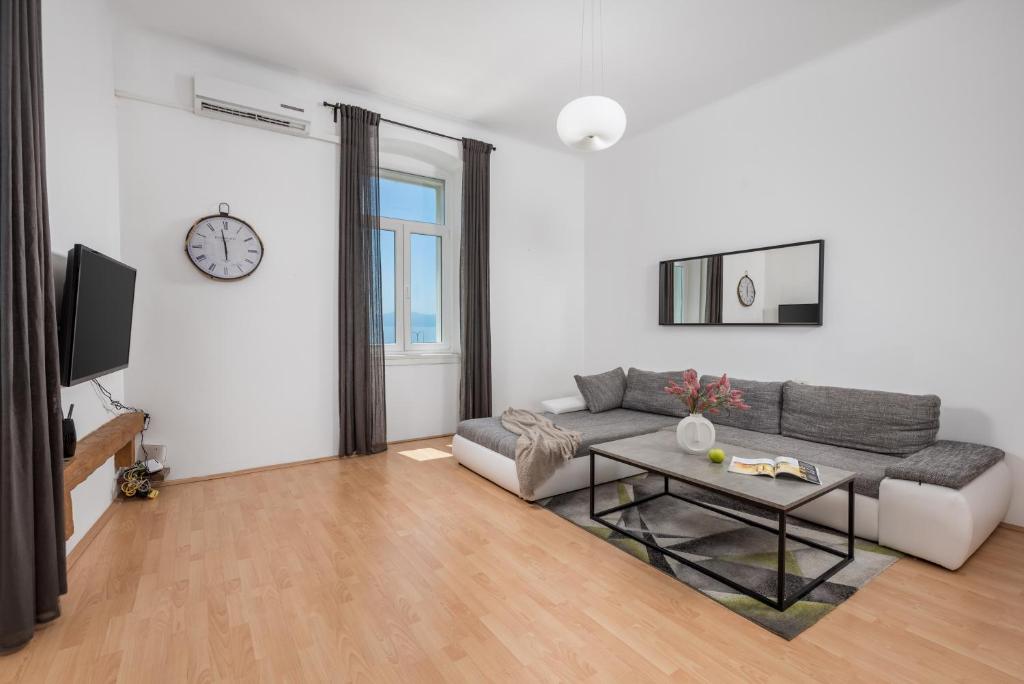 a living room with a couch and a table at Step to the Sea apartment in Rijeka