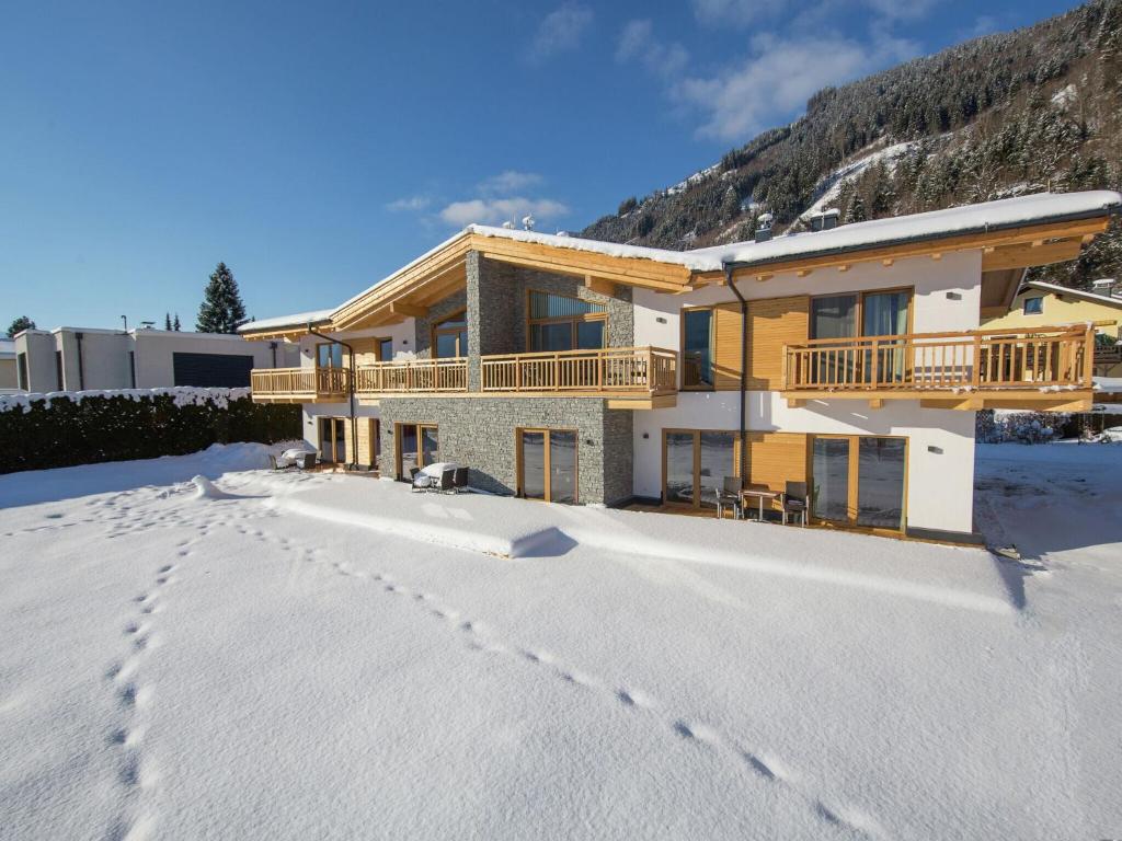 a house in the snow with footprints in the snow at Luxurious Apartment in Zell am See near Ski Area in Zell am See