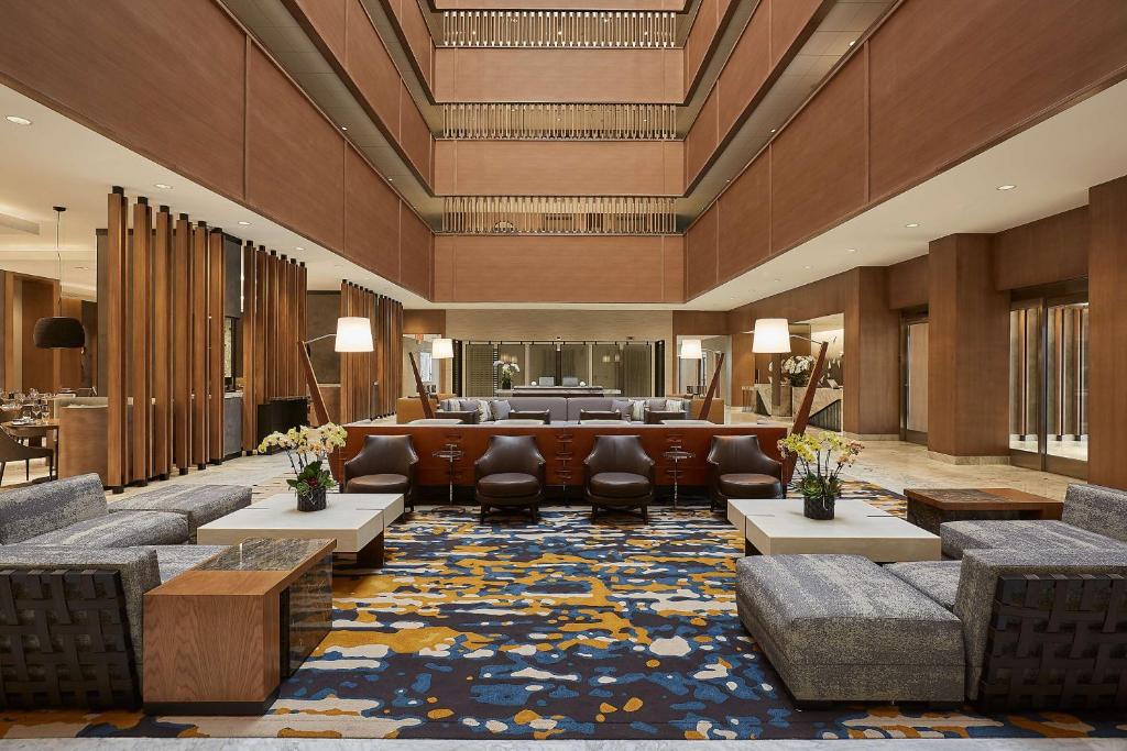 a hotel lobby with couches and a waiting room at Hyatt Regency John Wayne Airport Newport Beach in Newport Beach