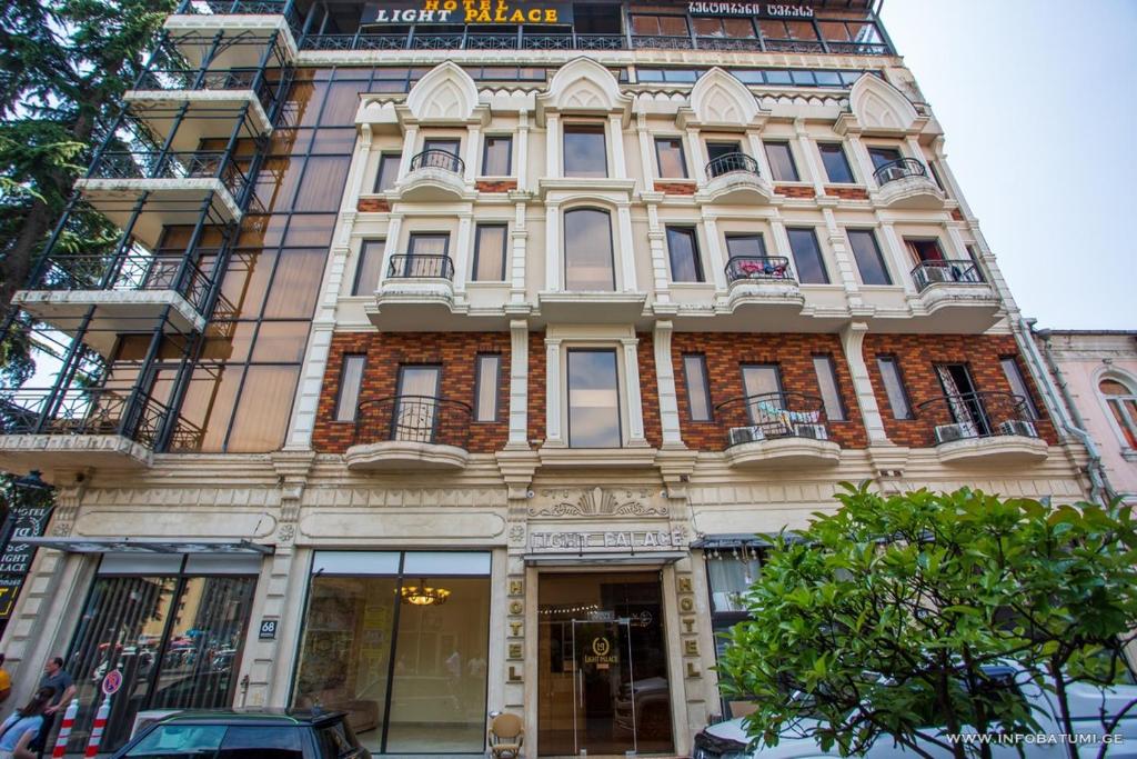 a large building on the corner of a street at Hotel Nica in Batumi