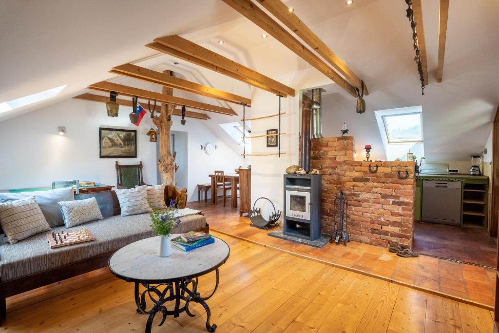 a living room with a couch and a fireplace at Horse Farm Holiday Pr' Kolenc in Zgornje Gorje