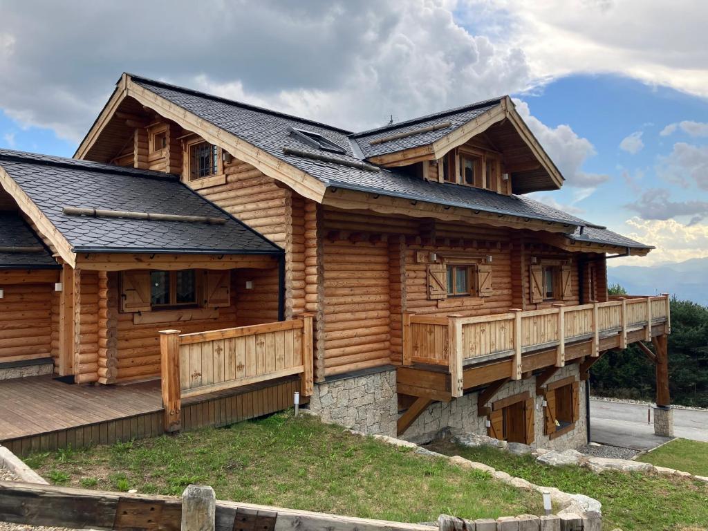 a log cabin with a porch and a deck at Saint Bernard in Font-Romeu-Odeillo-Via