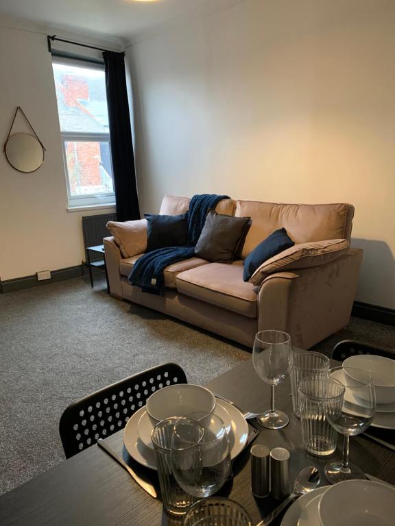 a living room with a couch and a table at Saltwell St - Delightful 3 Bedroom free parking free wifi in Gateshead