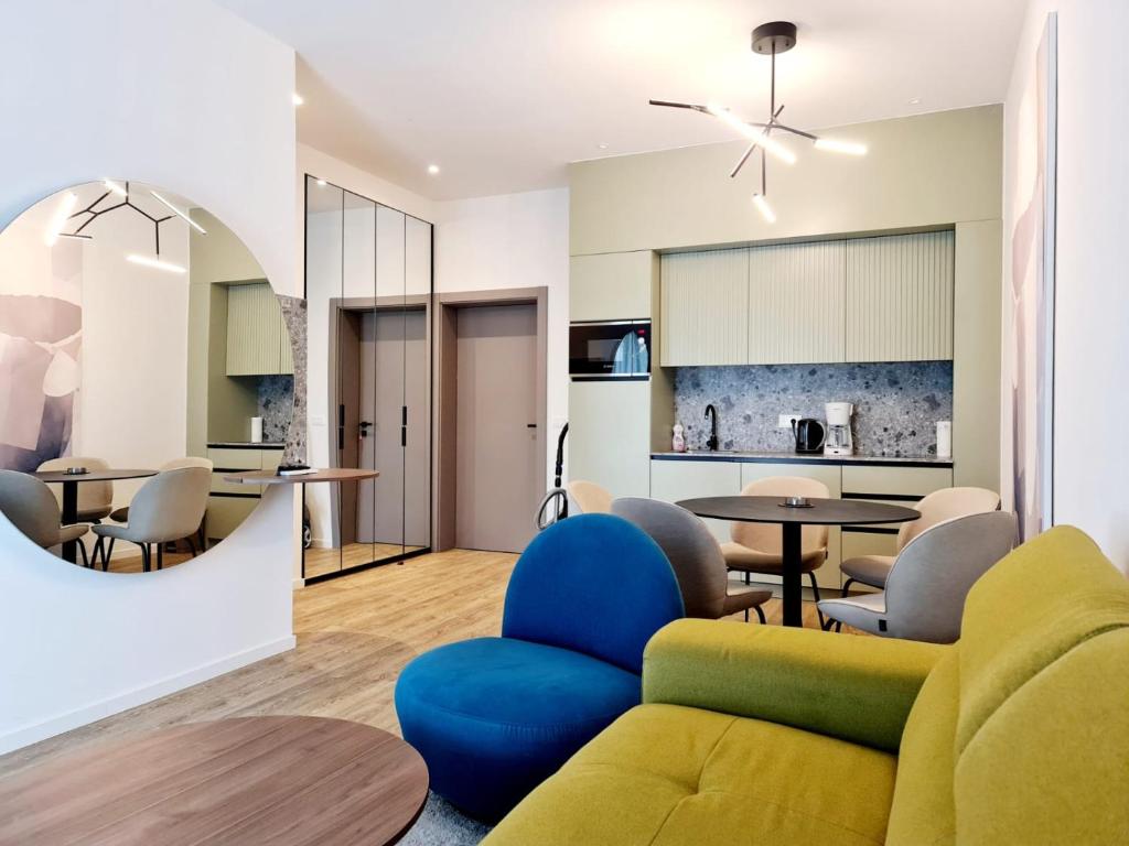 a living room and kitchen with a couch and chairs at Apartman Nika Makarska in Makarska