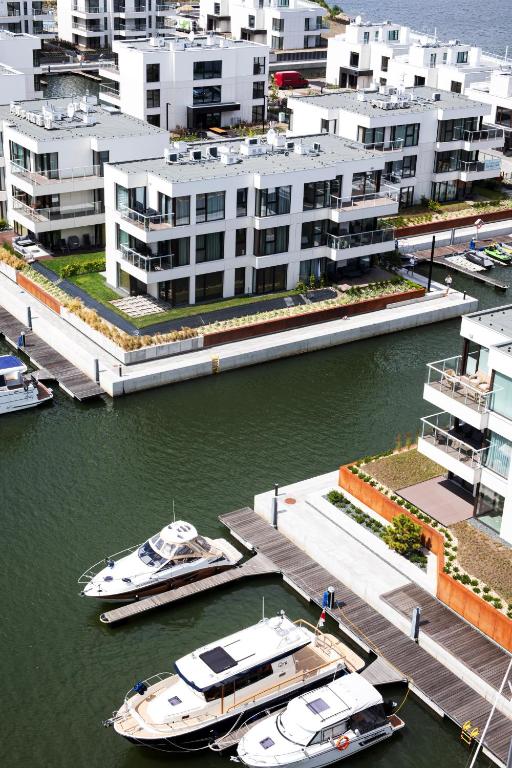 two boats docked at a dock in a harbor at GRANO HOTEL Solmarina in Wiślinka