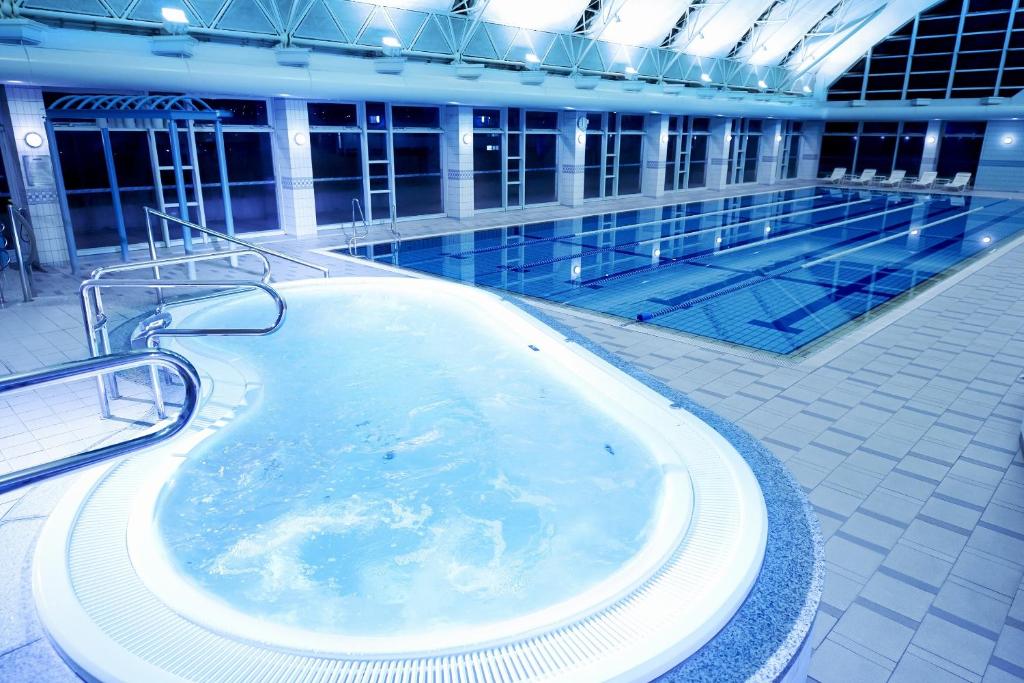 a large swimming pool with a hot tub on a cruise ship at Rihga Royal Hotel Hiroshima in Hiroshima