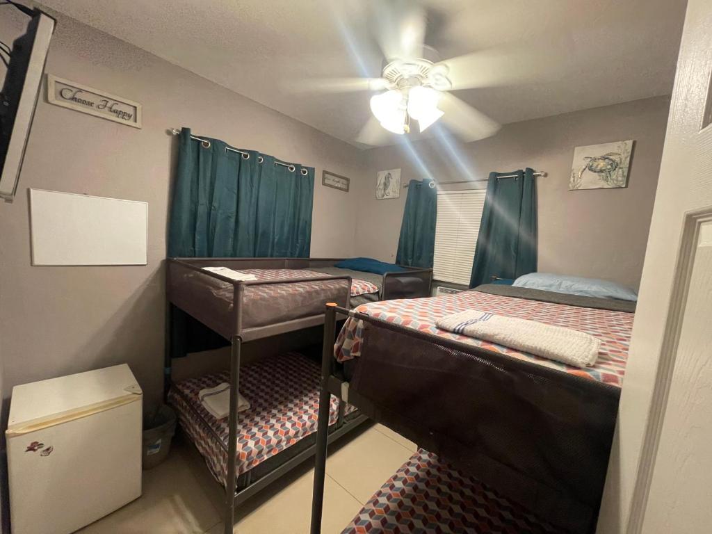 a room with two bunk beds and a ceiling at Miami Vibes "Hostel-Like" Shared Room in North Miami