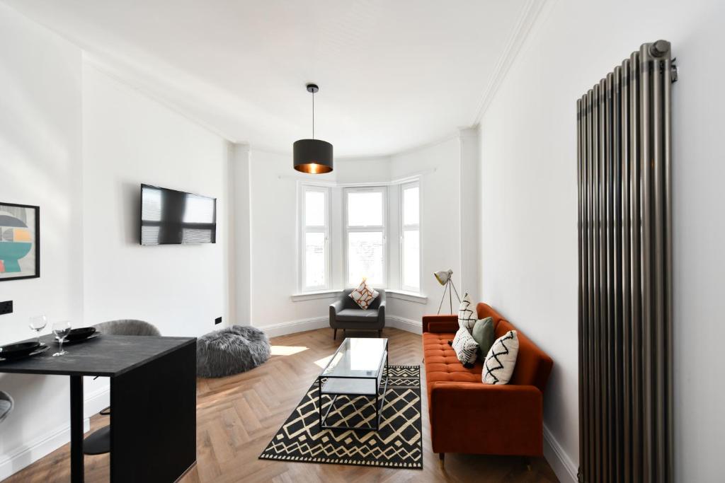 a living room with a couch and a table at Prestwick Green Pad in Prestwick