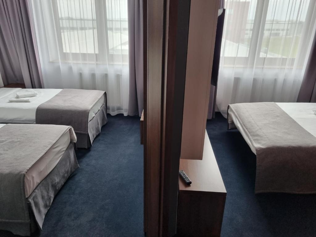 Postel nebo postele na pokoji v ubytování Terminal Hotel