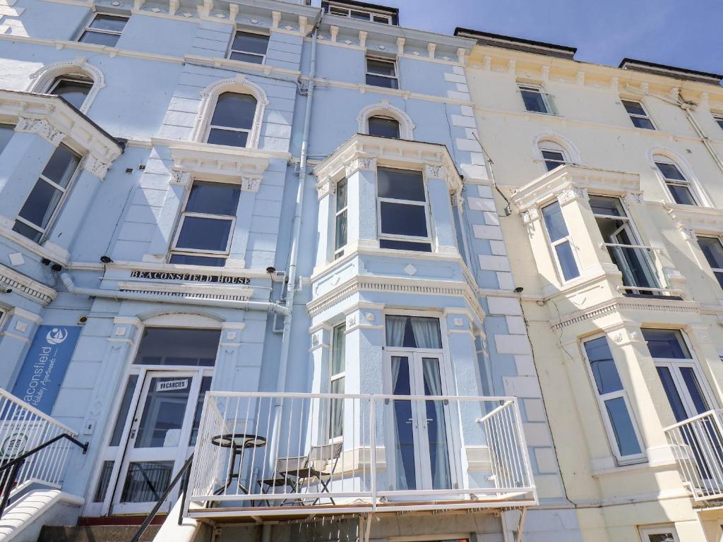 a blue building with a balcony in front of it at 6 Beach View Beaconsfield House in Bridlington