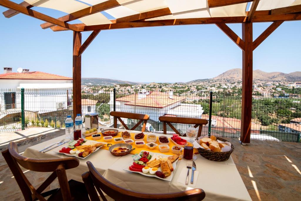 a table with food on it with a view at Estia Hotel in Gokceada Town