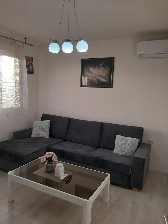 a living room with a couch and a coffee table at Apartman Vukoja - Posušje in Posušje