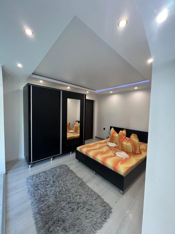 a bedroom with a large bed and a rug at Casa Tofalvi in Sovata