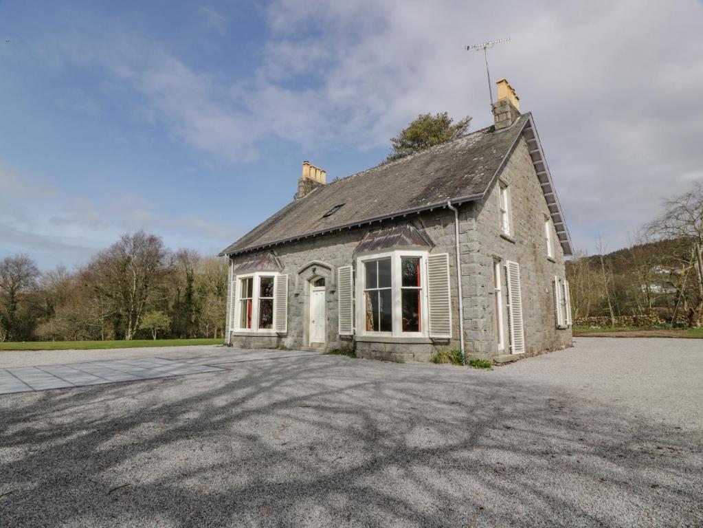 an old stone house with a large driveway at Auchenvhin - Rockcliffe in Dalbeattie