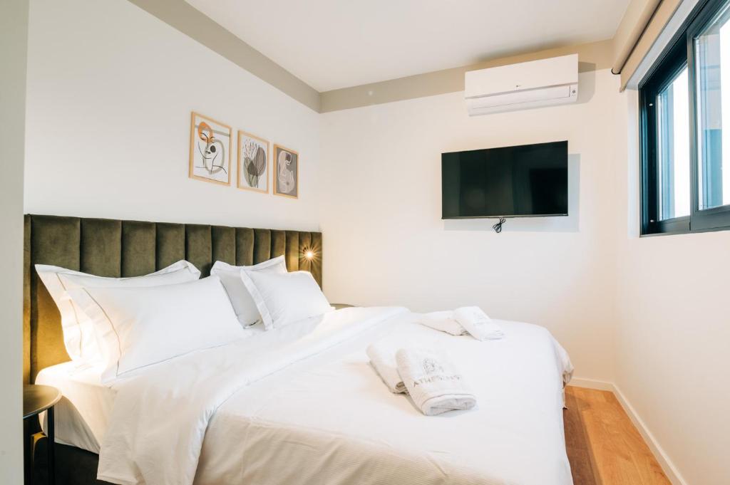 Postel nebo postele na pokoji v ubytování Athesense Suites