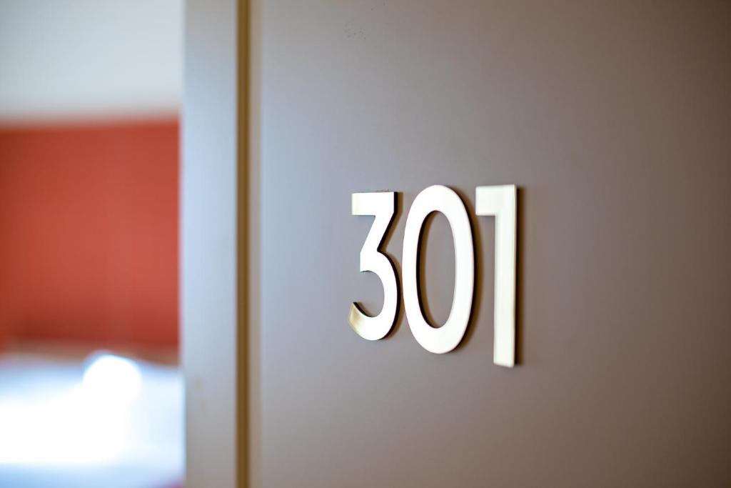 a door sign with the number on it at Sentho Roma in Rome