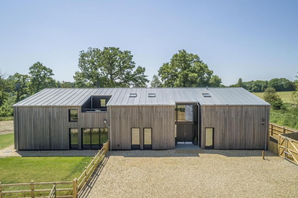 a wooden house with a metal roof at The Grain Store in Reepham