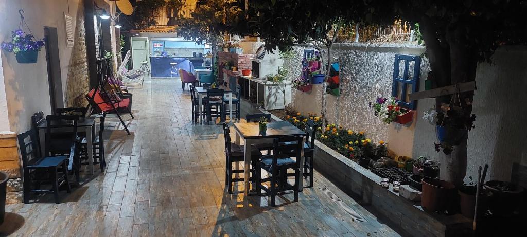 an empty restaurant with tables and chairs and a room with a unintention at ÇAMLIK PANSİYON in Antalya