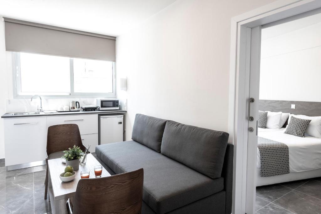 a living room with a couch and a bed at Blazer Residence in Larnaka