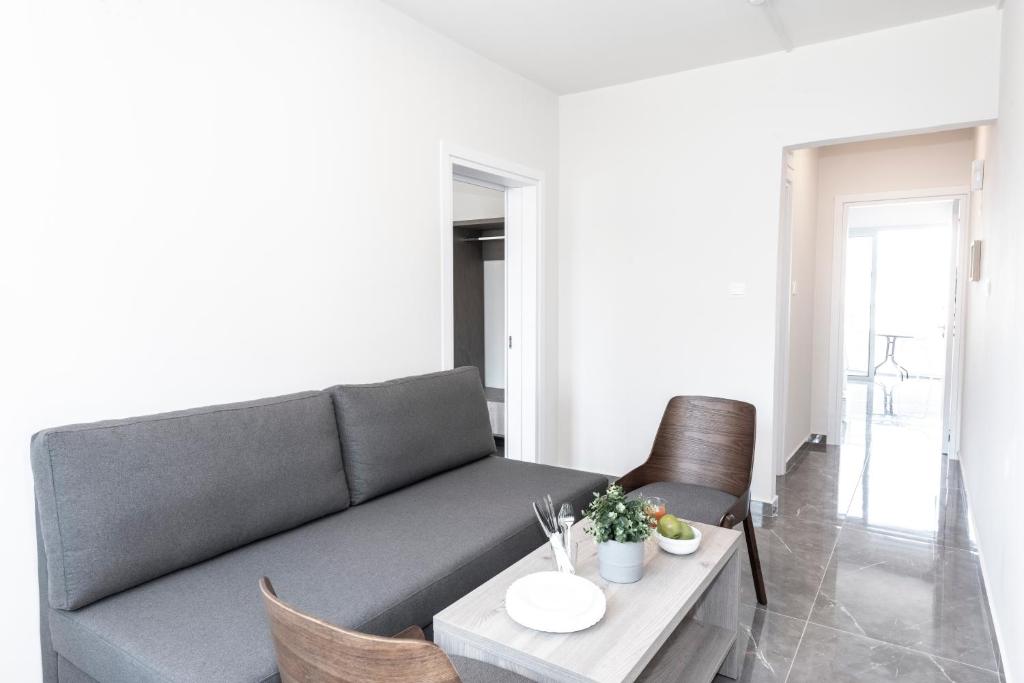 a living room with a couch and a table at Blazer Residence in Larnaka