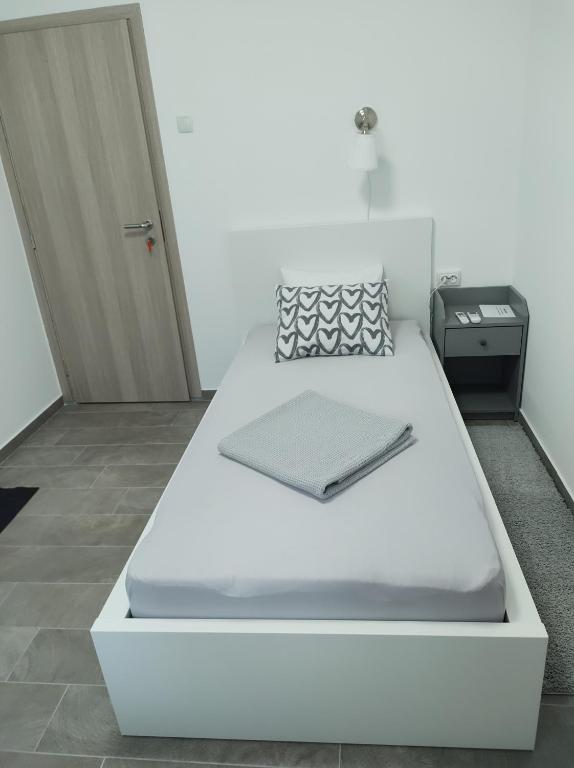 a large white bed in a room with a door at Happy room in Karlovac