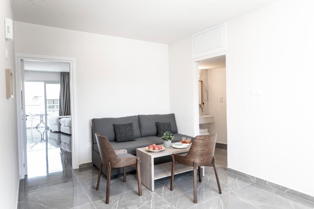 a living room with a couch and a table and chairs at Blazer Residence in Larnaka