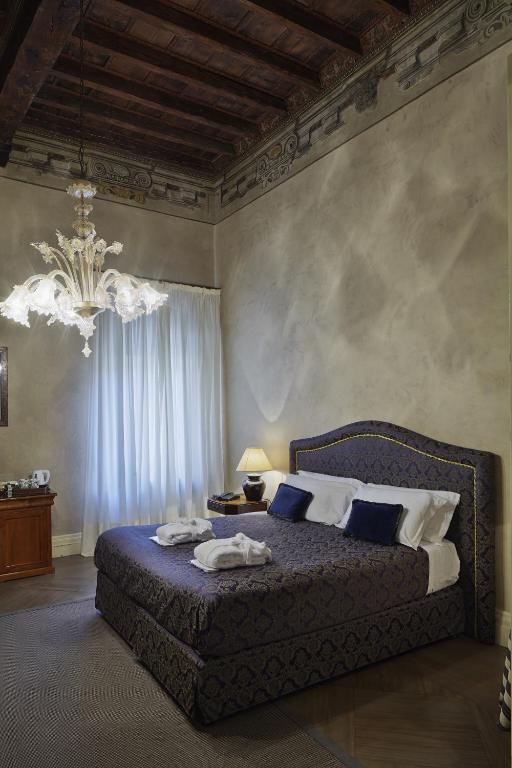 Postel nebo postele na pokoji v ubytování Albergo Cappello