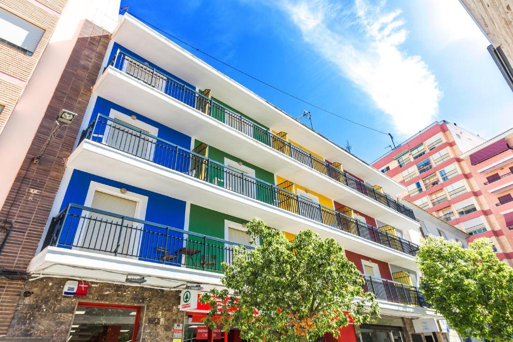 a building with colorful balconies on a city street at Hostal El Mercat in Villajoyosa