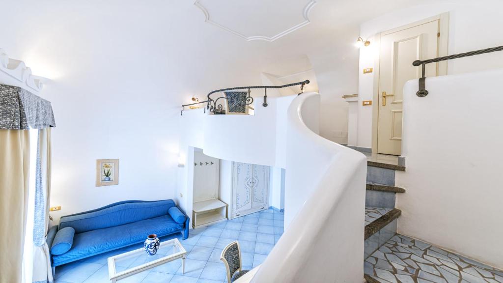 a staircase in a room with a blue couch at Hotel Nettuno in Ischia