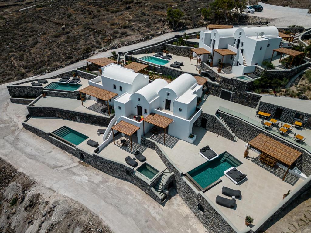 an aerial view of a house with a swimming pool at Arise Suites in Imerovigli