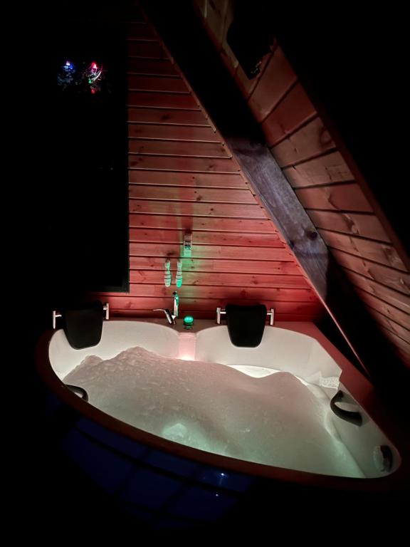 a bath tub in a room with a window at Hidden Garden Bungalow in Trabzon