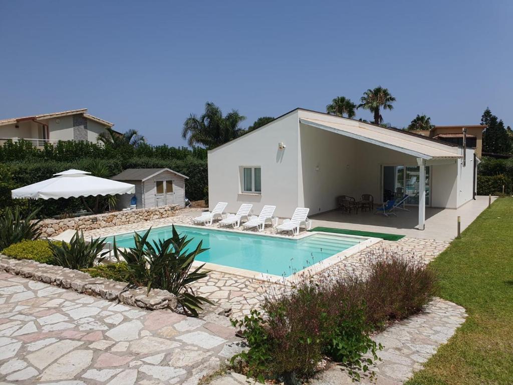 a house with a swimming pool in front of a house at Villa Limone in Castellammare del Golfo