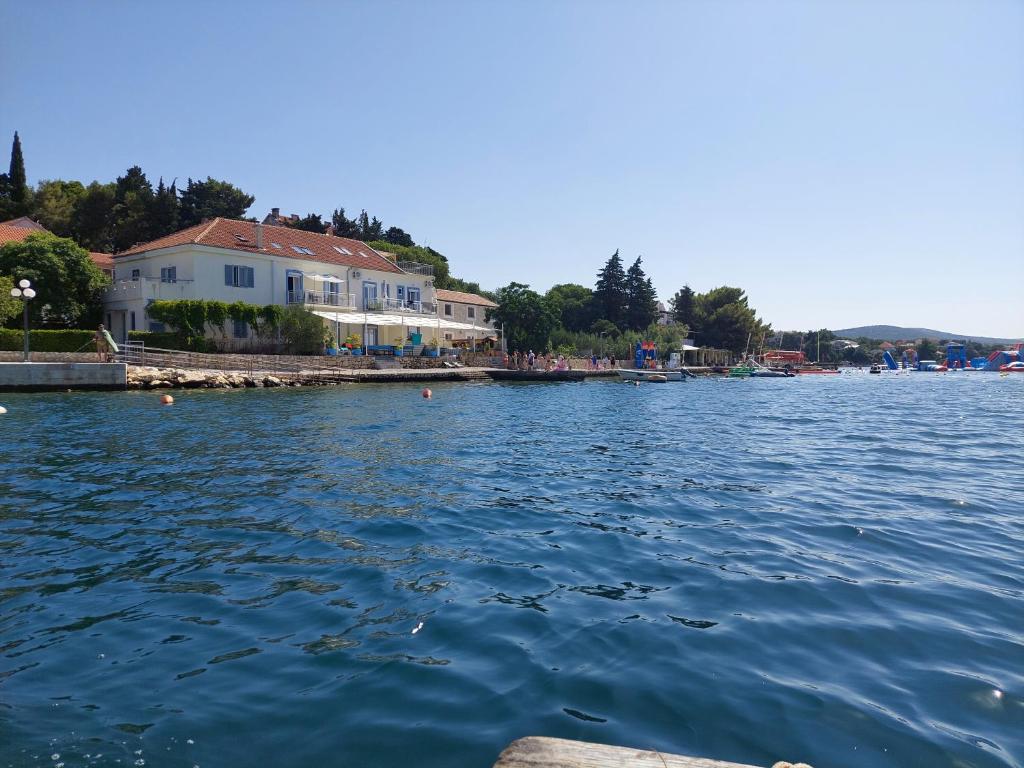 a view of a body of water with houses at Group Holiday Accommodation Natura Croatia, Sleeps Up To 13 People in Maslenica