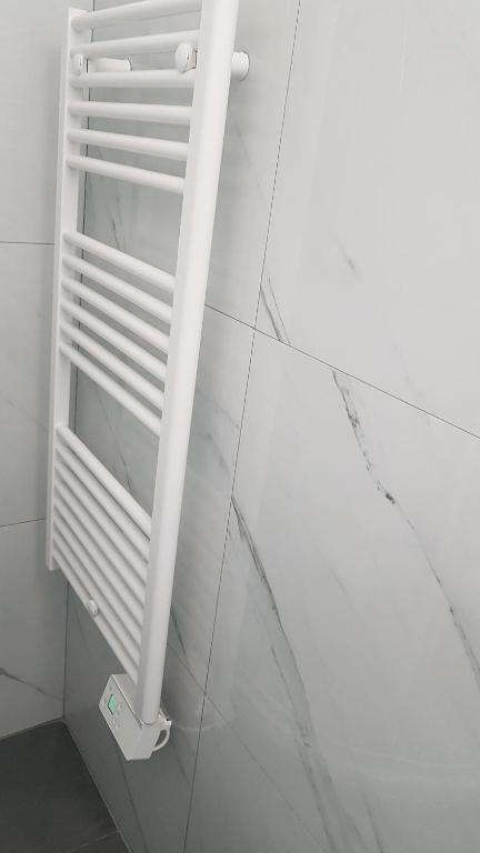 a white shelf in a bathroom with a wall at studio à 2 mn à pied de la plage in Nice
