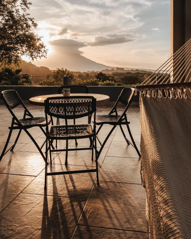 a patio with two chairs and a table on a porch at Ananda Guesthouse in Balgue