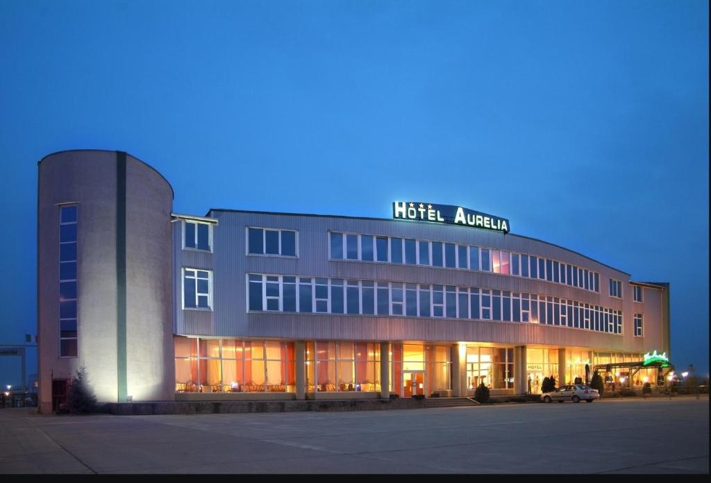 a building with a sign on the front of it at Hotel Aurelia in Timişoara