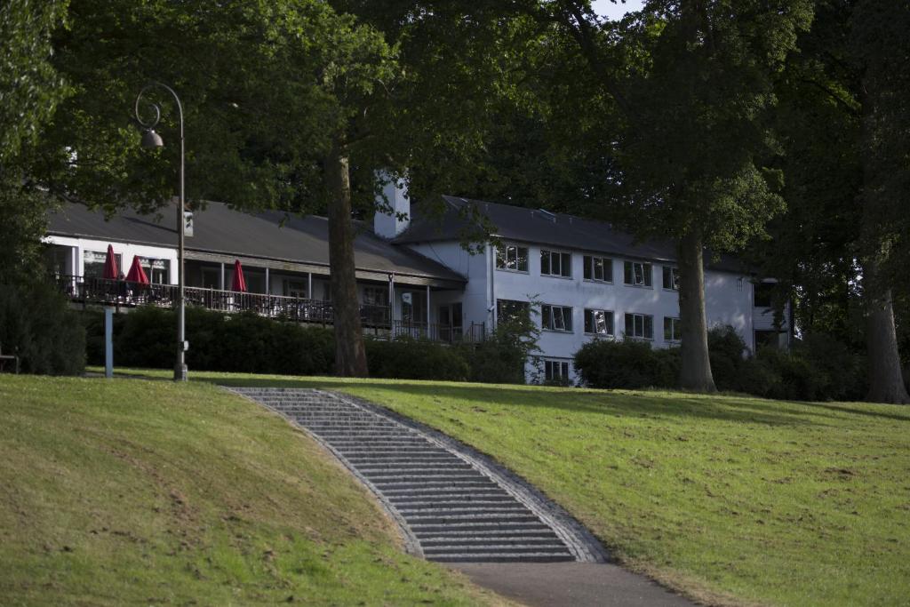 a large white building with stairs in front of it at Hotel Strandparken in Holbæk