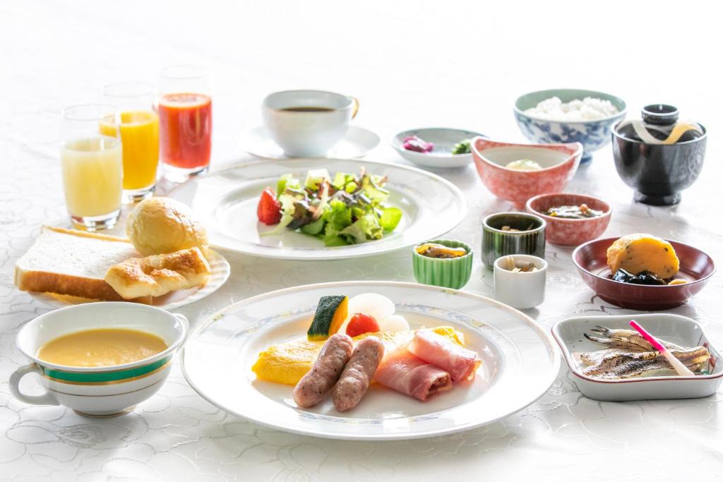 a table topped with plates of food and drinks at Kuretake Inn Nagoya Hisayaodori in Nagoya