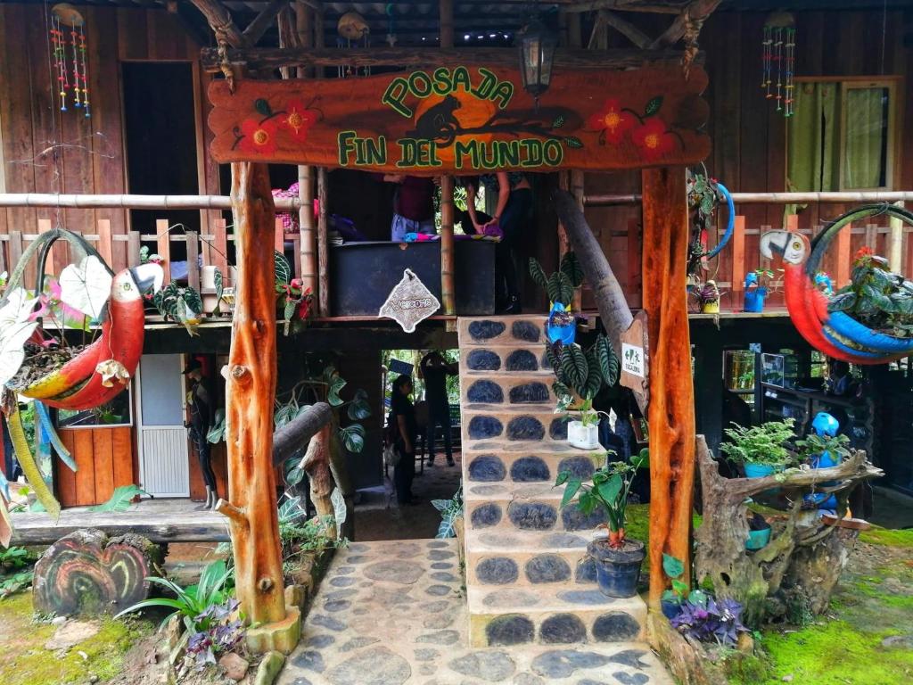 a small building with a sign that reads fun be hunted at Posada Fin del Mundo in Mocoa