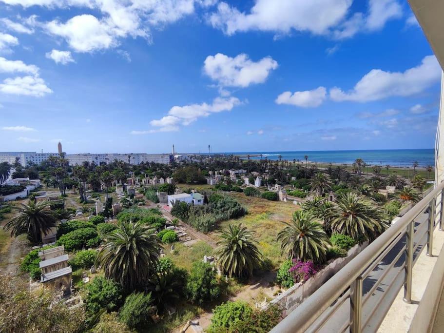 a view of a cemetery with palm trees and the ocean at Super appartement avec vue sur mer in Casablanca