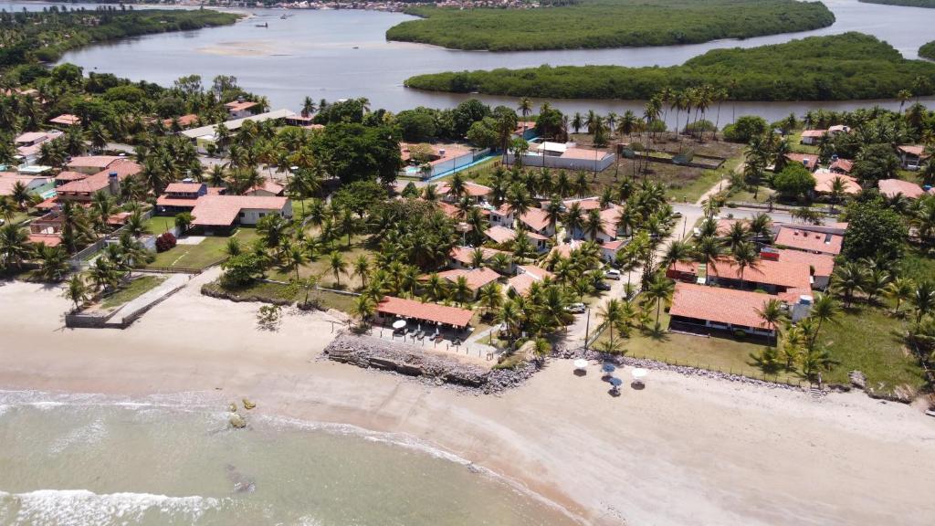an aerial view of a resort on a beach at Bangalos do Pontal in Japaratinga