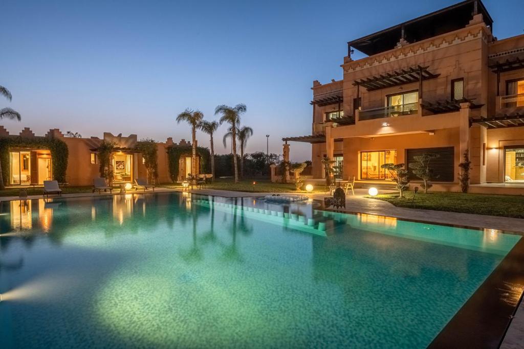 a large swimming pool in front of a house at Villa Dar Laila in Marrakech