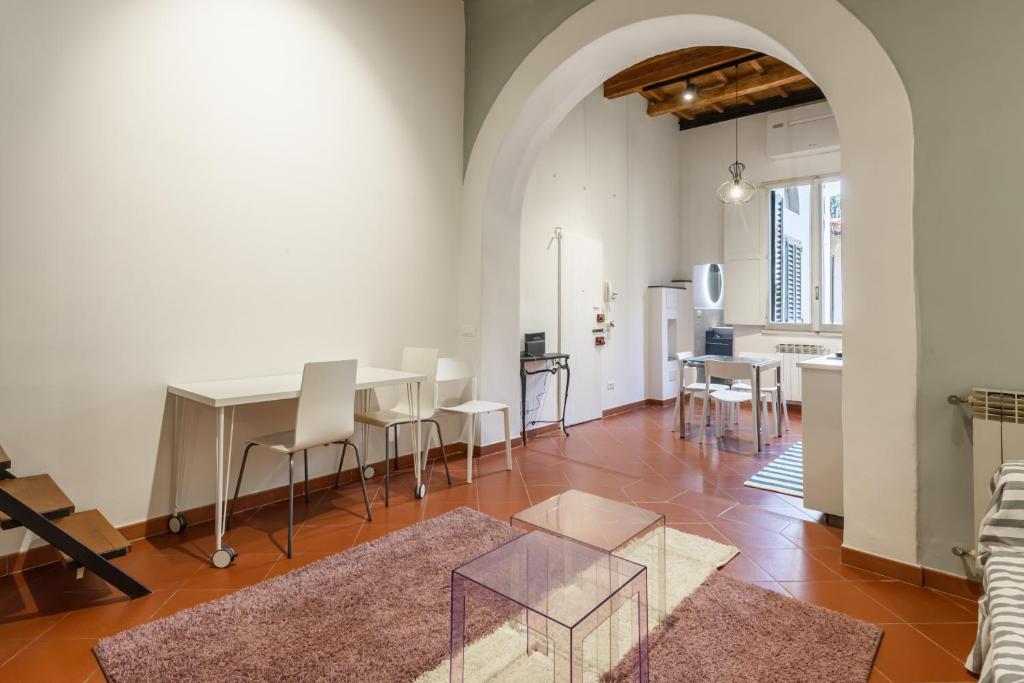 a living room with a table and chairs in it at Classic Loft by Mmega in Florence