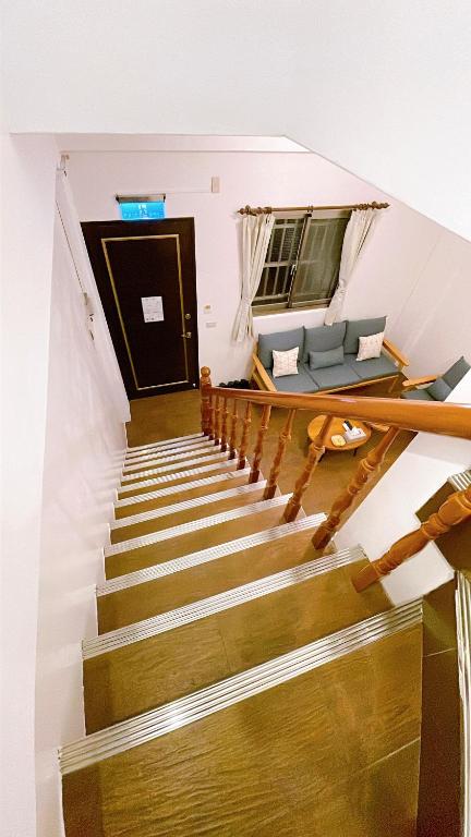 a staircase with a couch and a table at Sun B&amp;B in Taitung City
