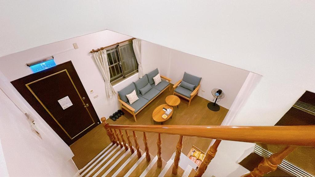 an overhead view of a living room with chairs and a door at Sun B&amp;B in Taitung City