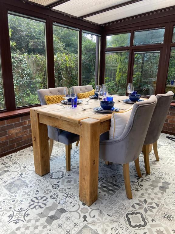 a wooden table in a room with windows at Stunning quirky home in Amble in Amble